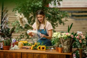 Florist woman making a bouquet of fresh flowers in a flower shop